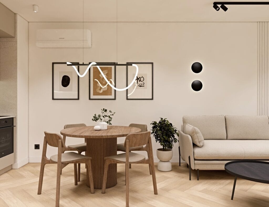 Jadalnia w stylu skandynawskim z okrągłym drewnianym stołem, czterema dopasowanymi krzesłami i nowoczesną falistą lampą wiszącą.