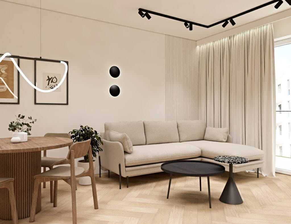 Nowoczesny salon z beżową sofą w kształcie litery L, okrągłym drewnianym stołem jadalnianym i stylowym oświetleniem.