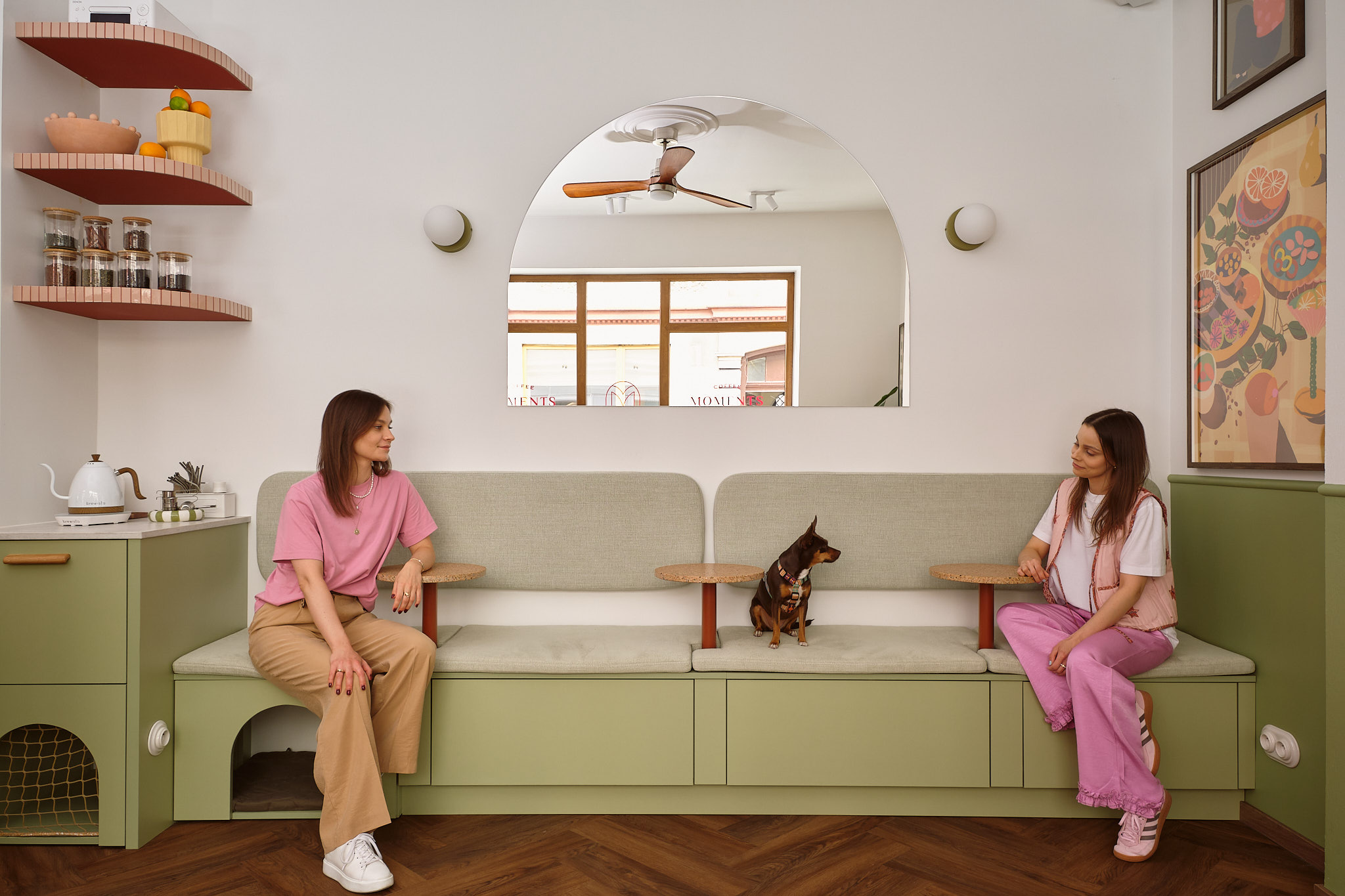 zielona tapicerowana loża oraz lustro w kształcie łuku